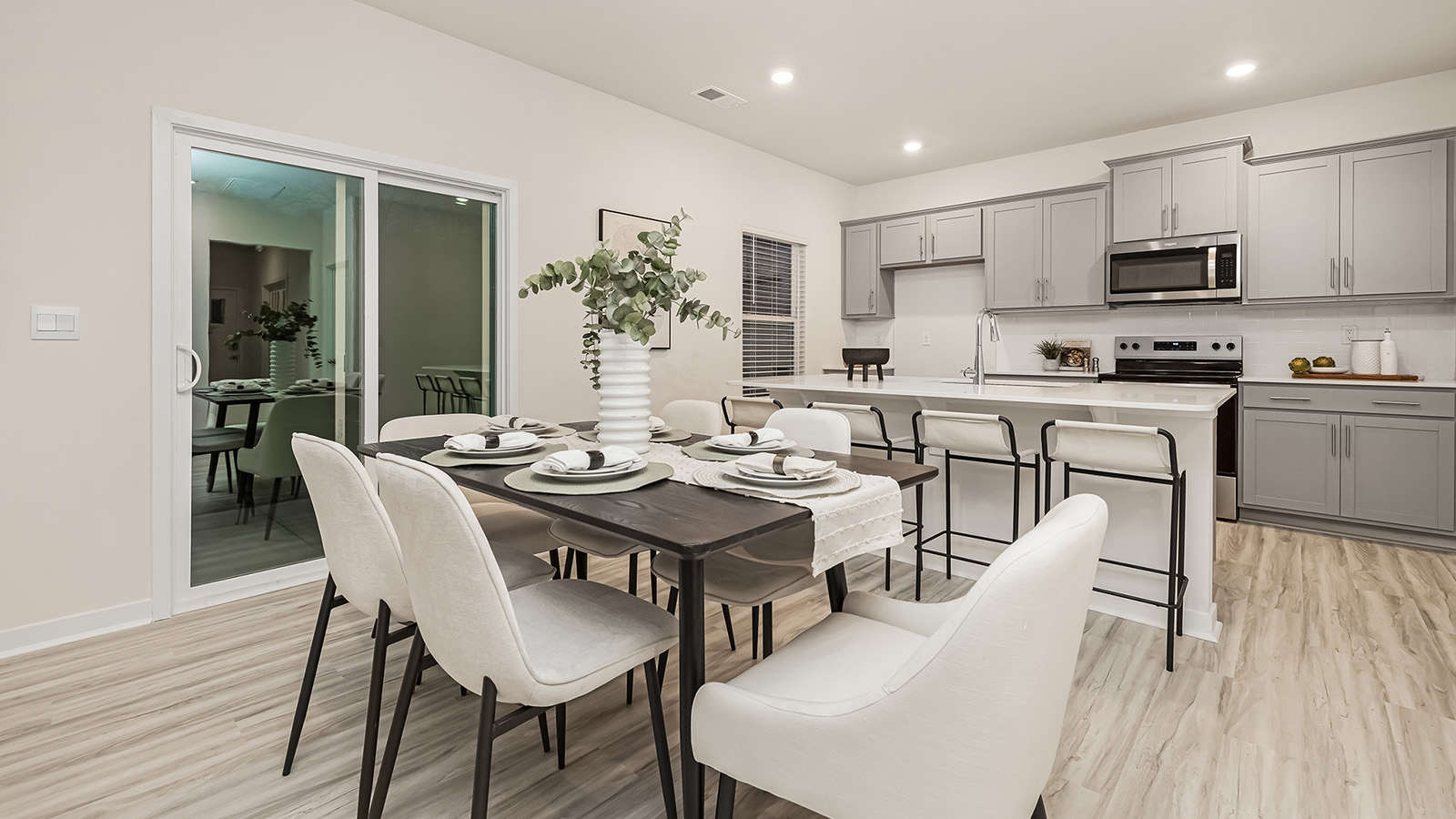 Dining room with wood floors, and sliding glass back door