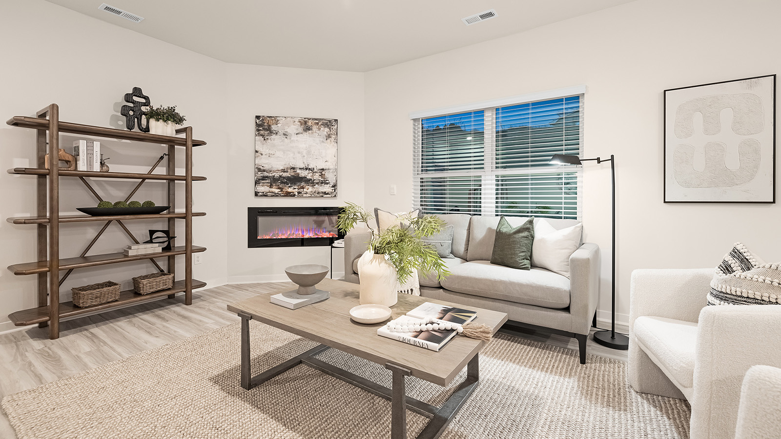 livinliving room with electric fireplace and large windowliving room with electric fireplace and large windowg room with wood floors, electric fireplace and large window