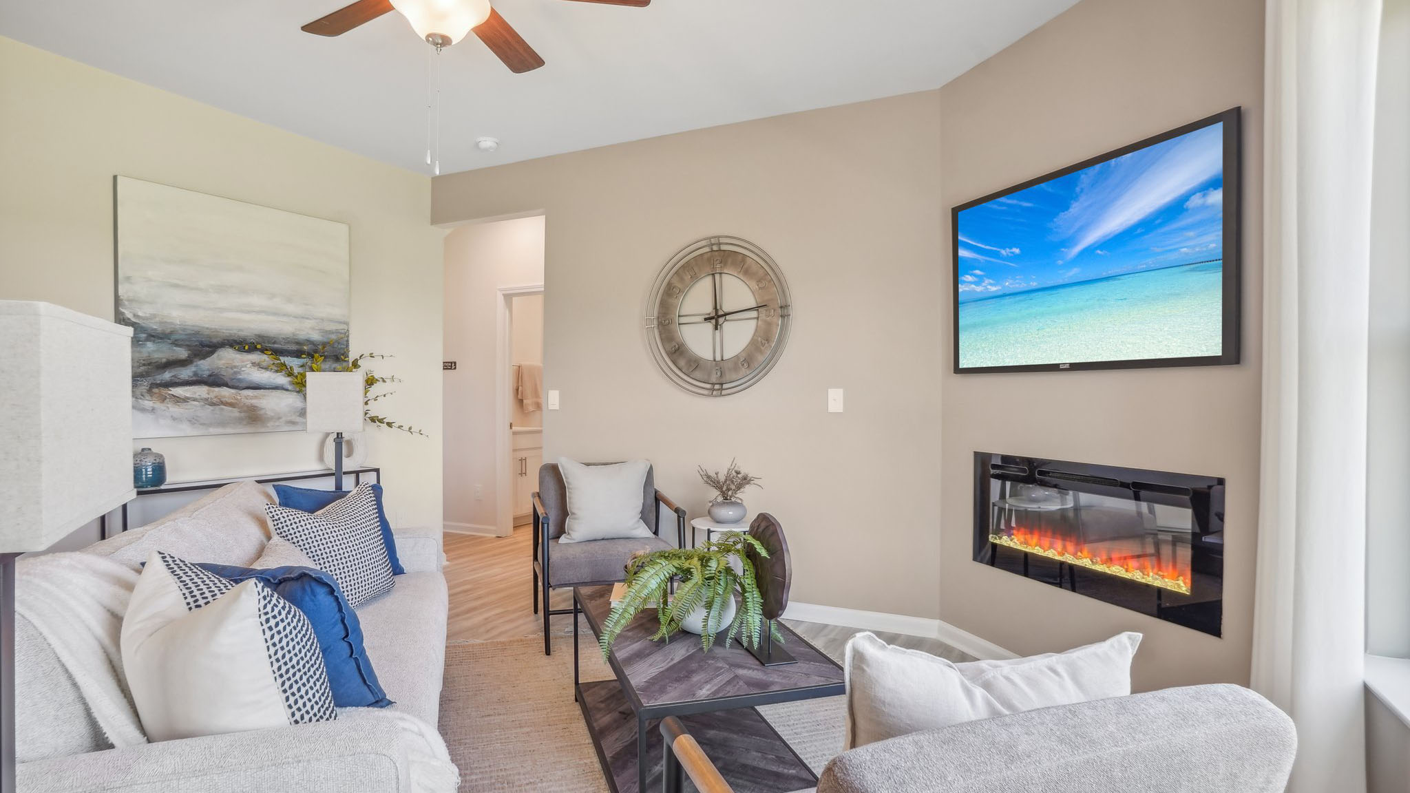 model open family room with windows and fireplace