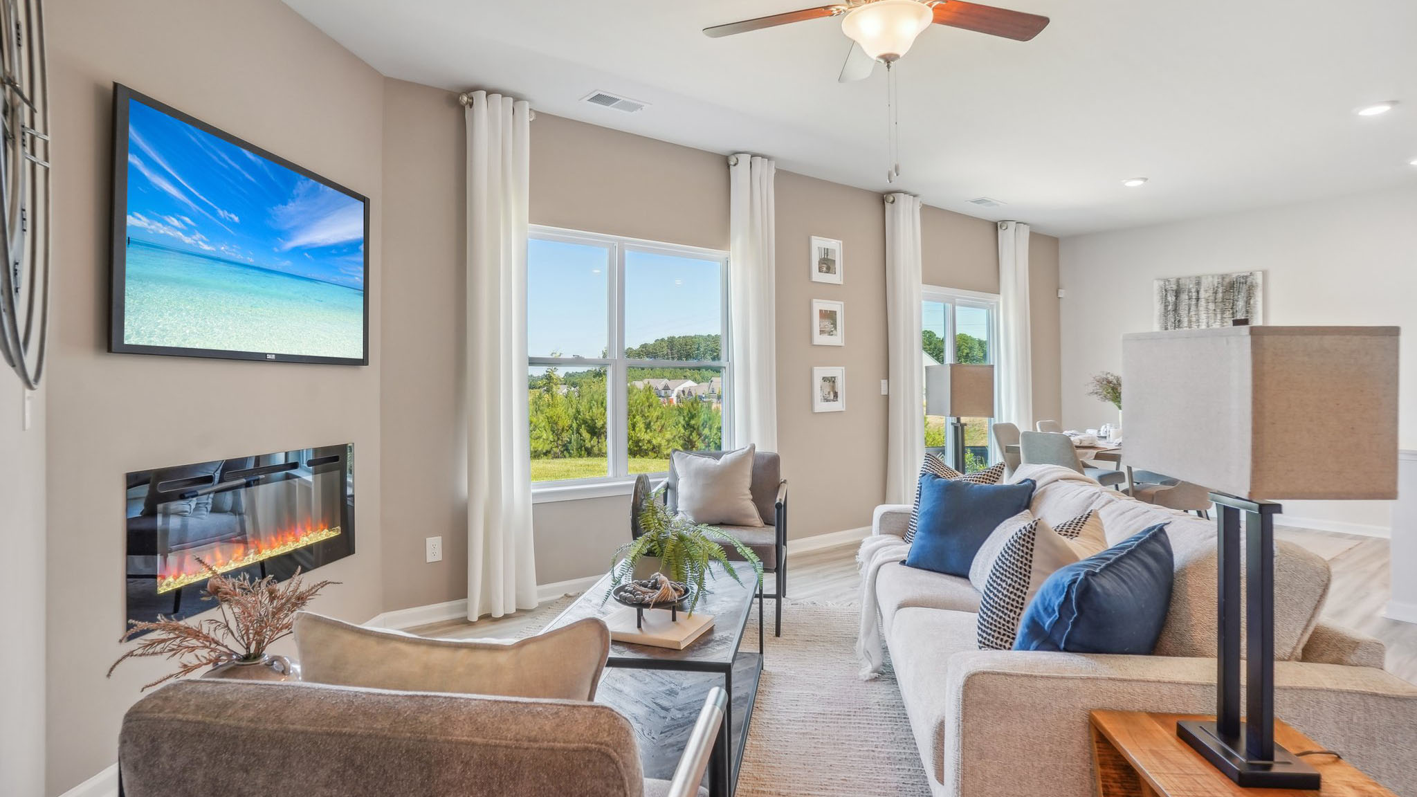 model open family room with windows and fireplace