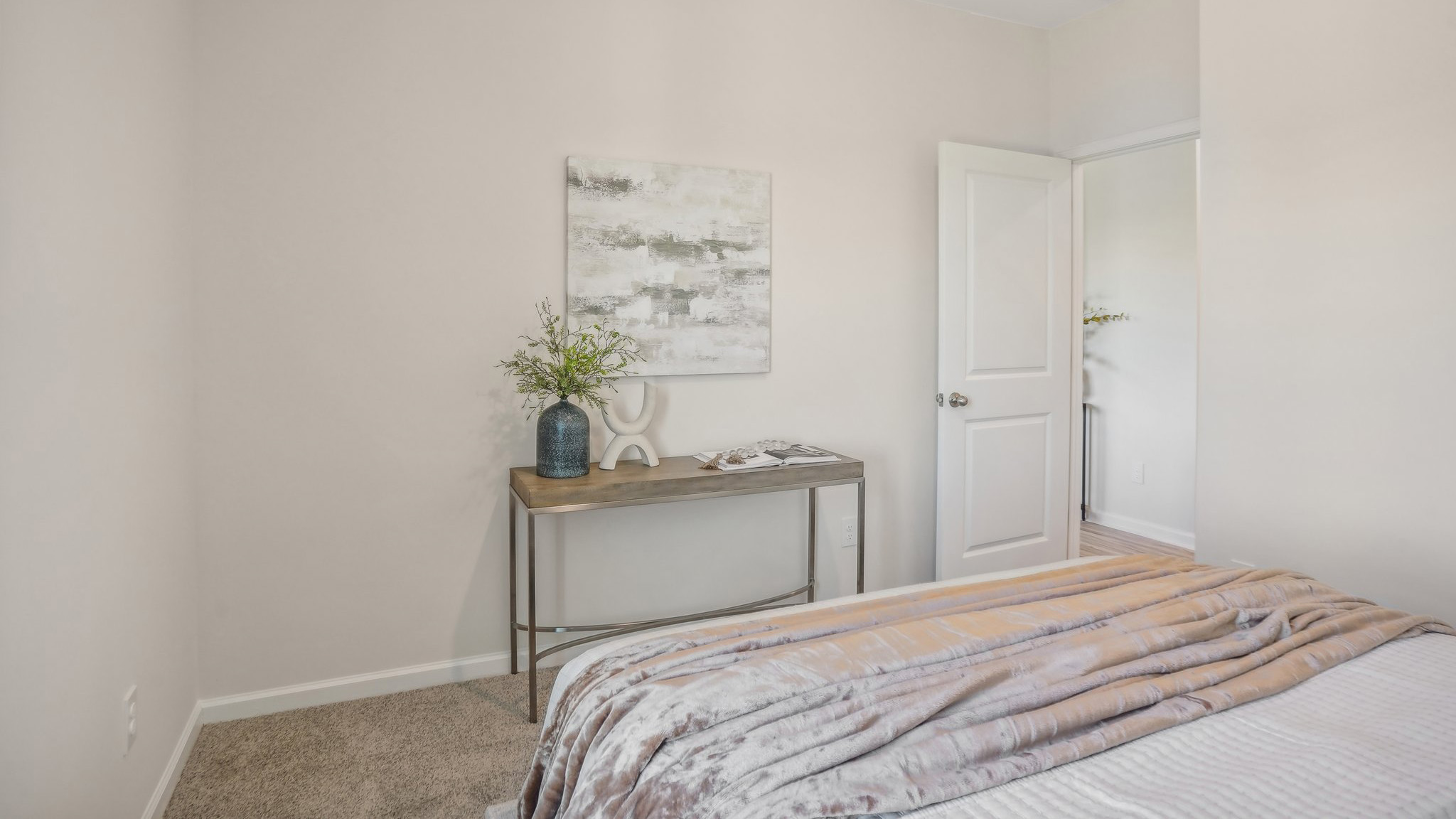 Model carpeted bedroom with large window