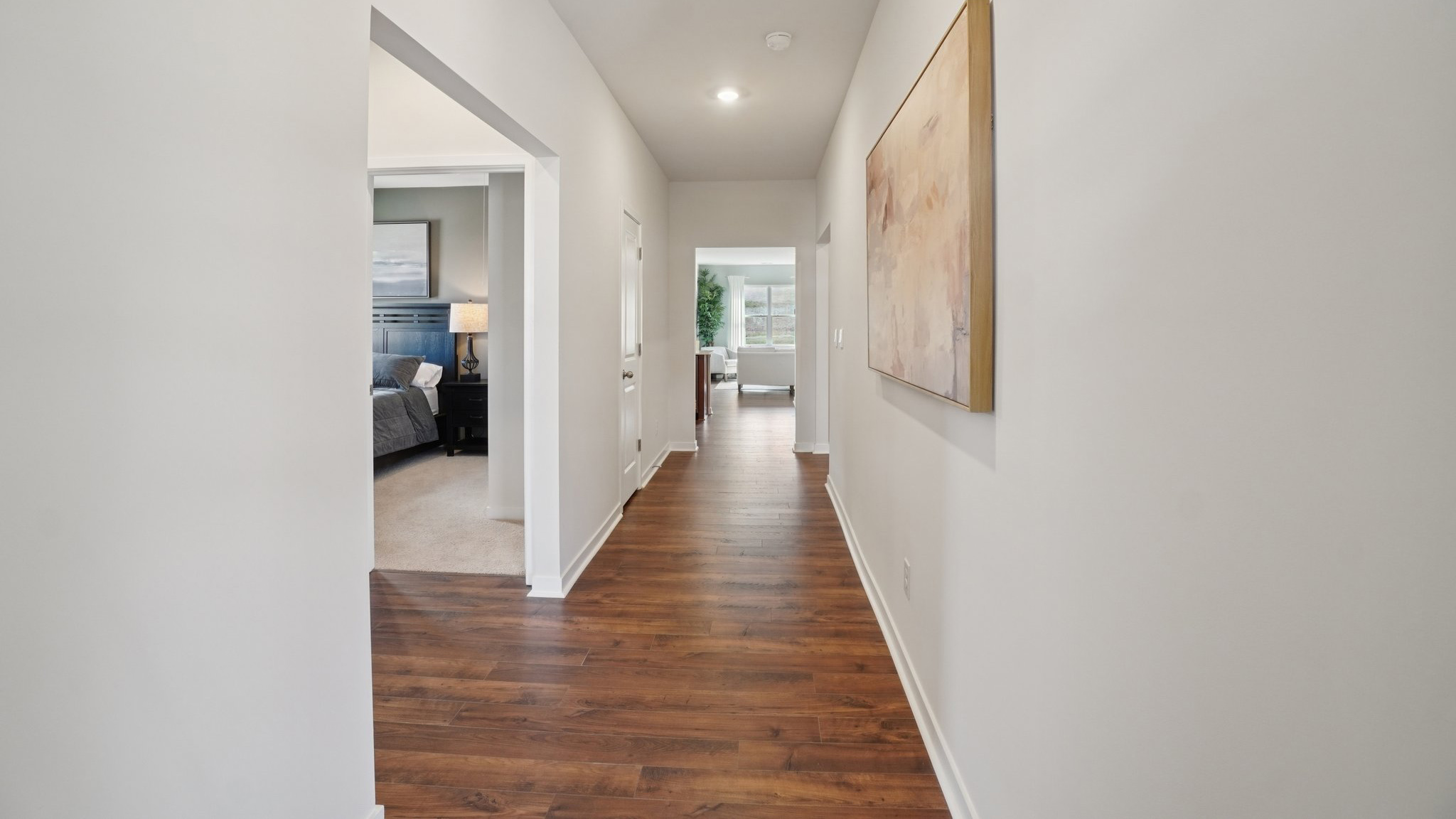 Front hallway with view of bedroom and open living space