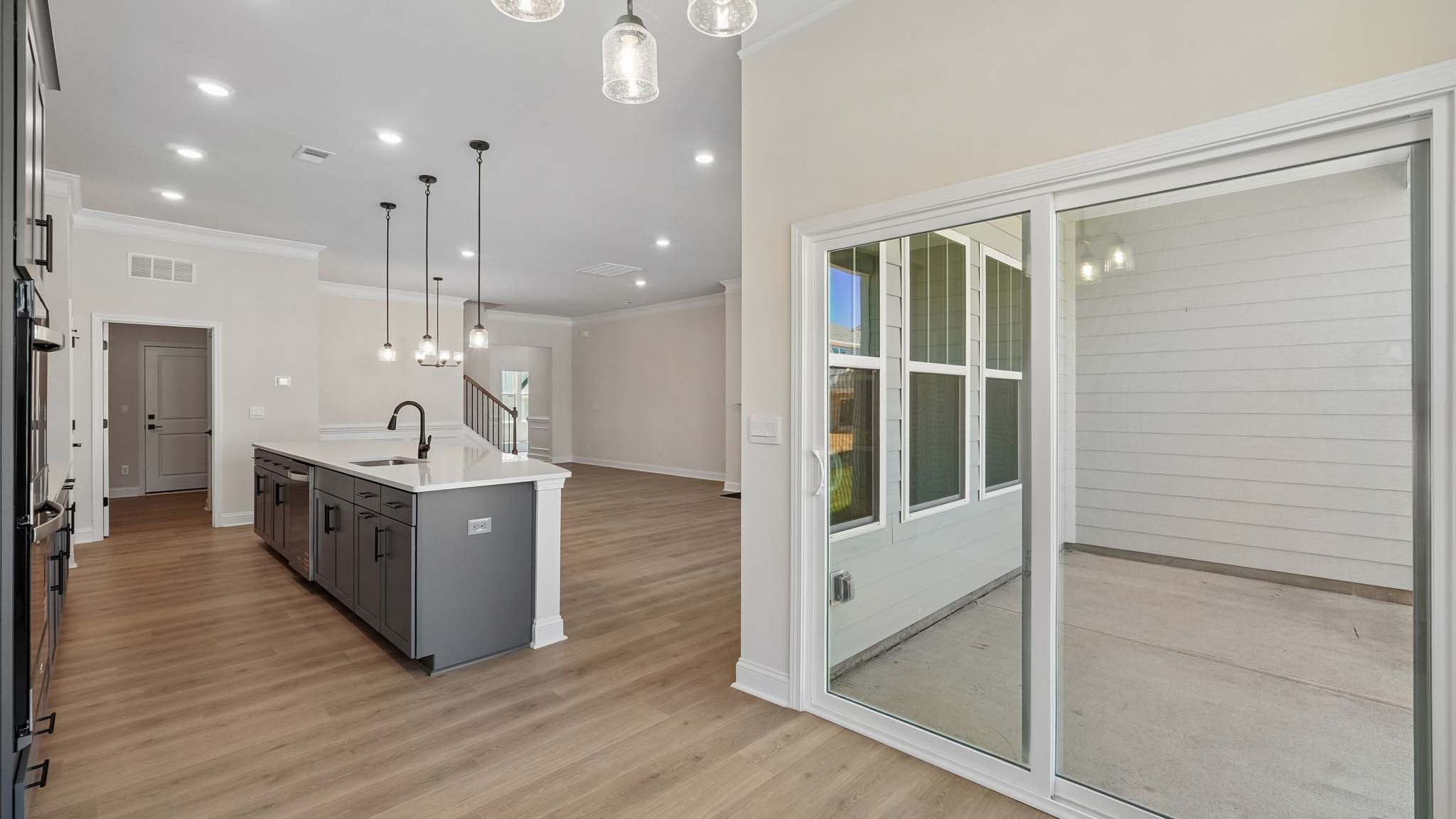 Dining area with wood floors and view of foyer
