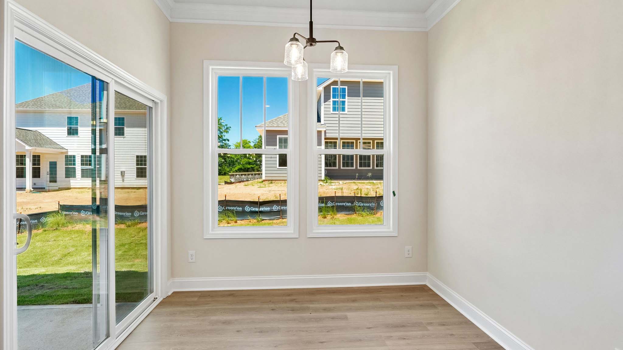 Dining area with wood floors and view of foyer