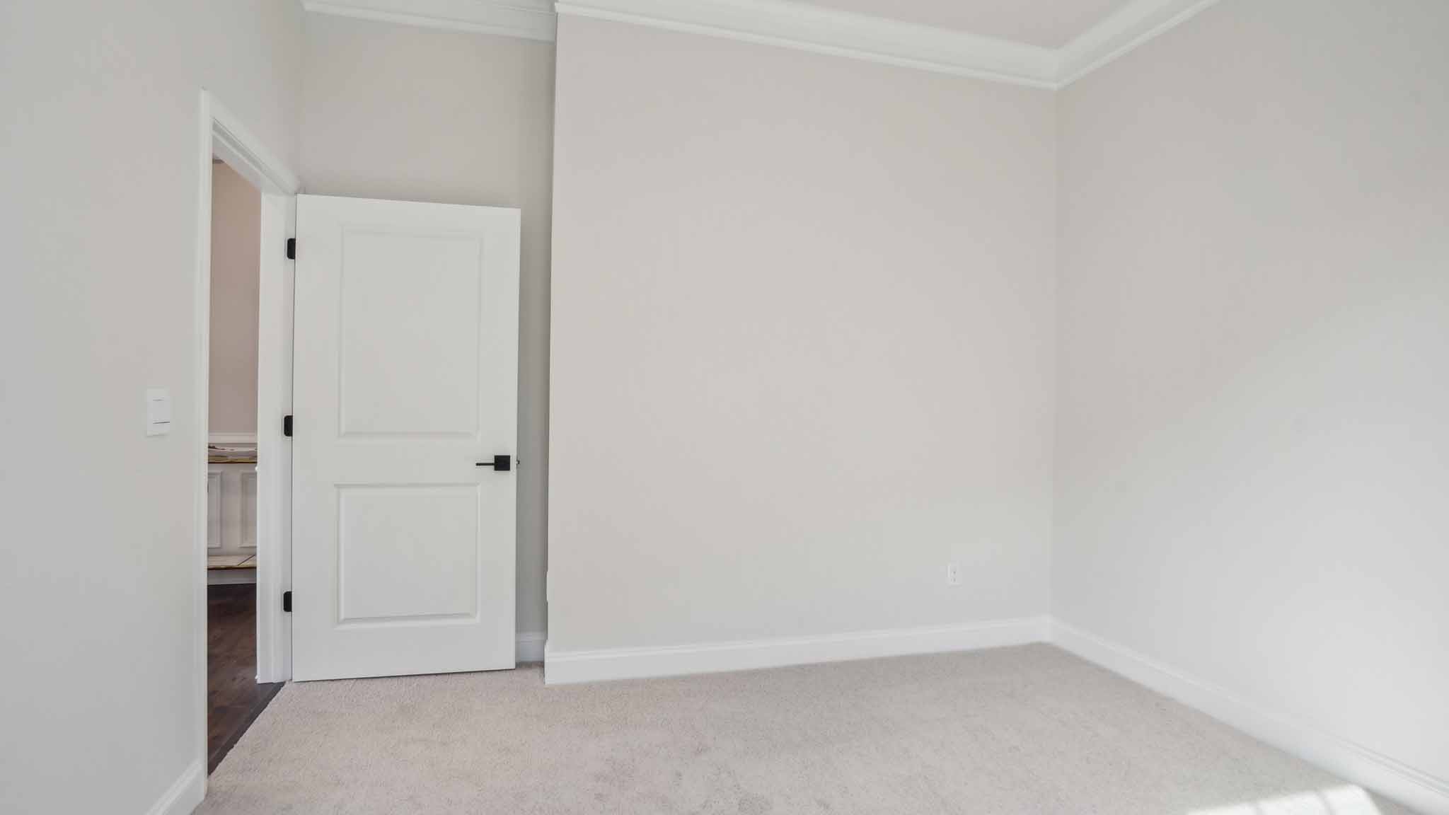 Carpeted bedroom three large windows