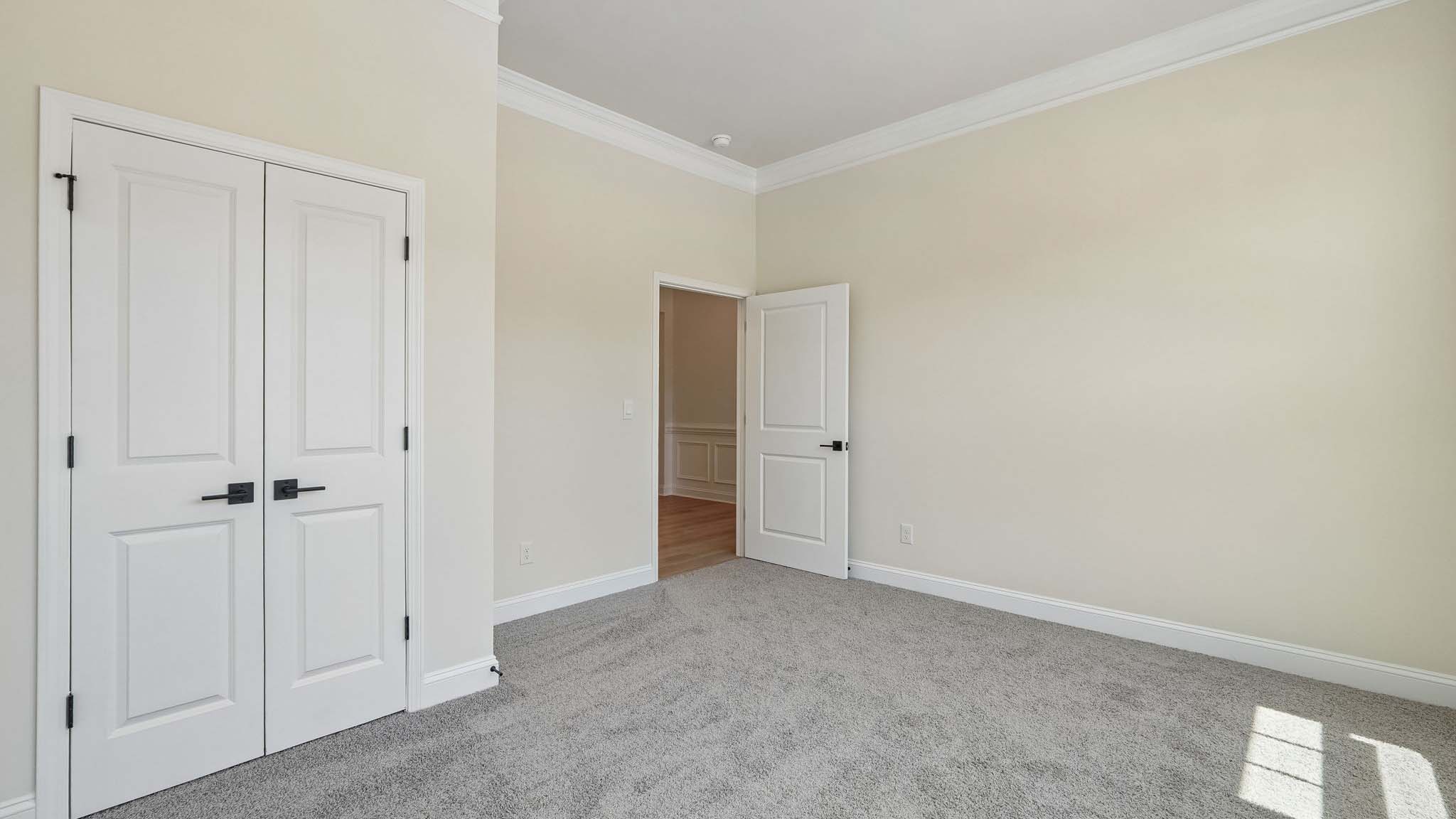 Carpeted bedroom three large windows