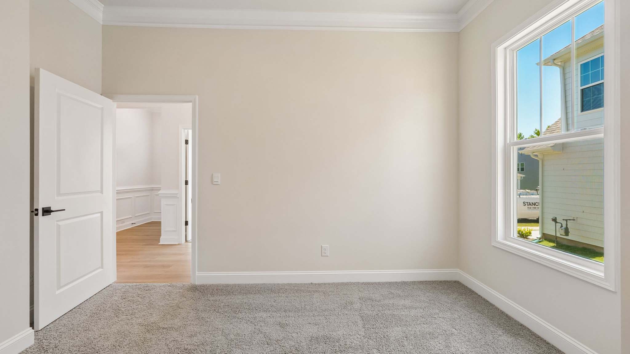 Carpeted bedroom three large windows