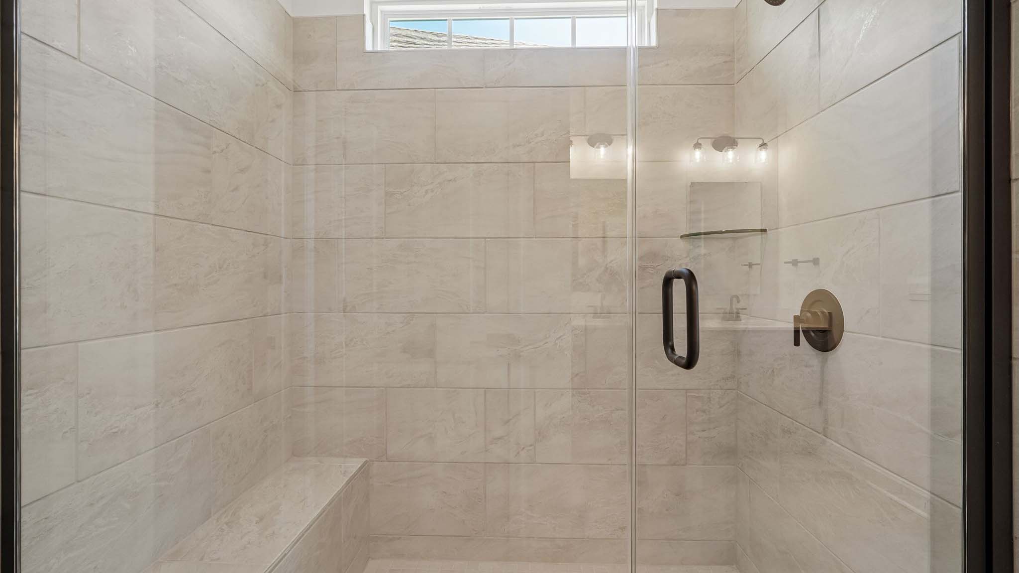 Primary bathroom with double sinks, white cabinets