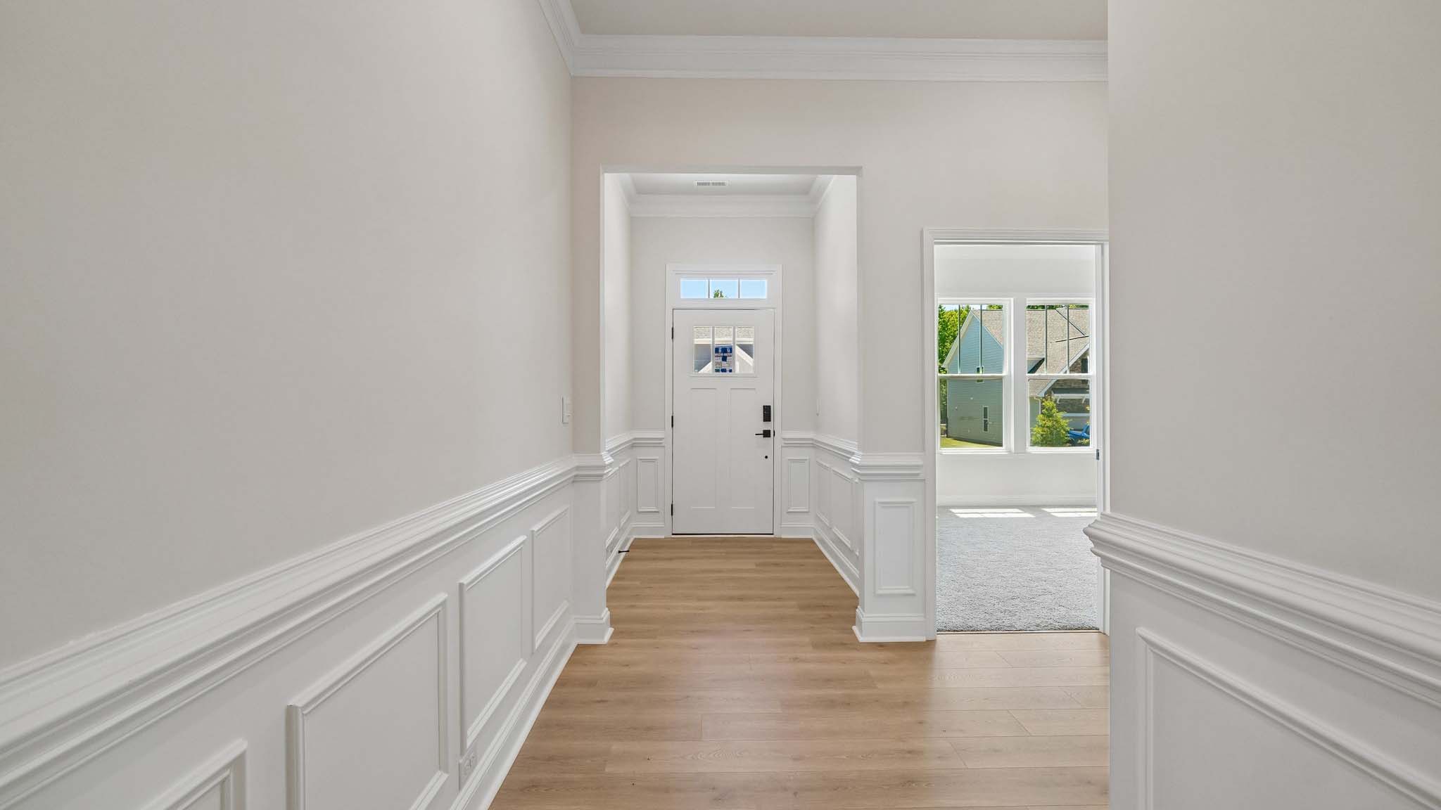 Welcoming foyer with wood floors