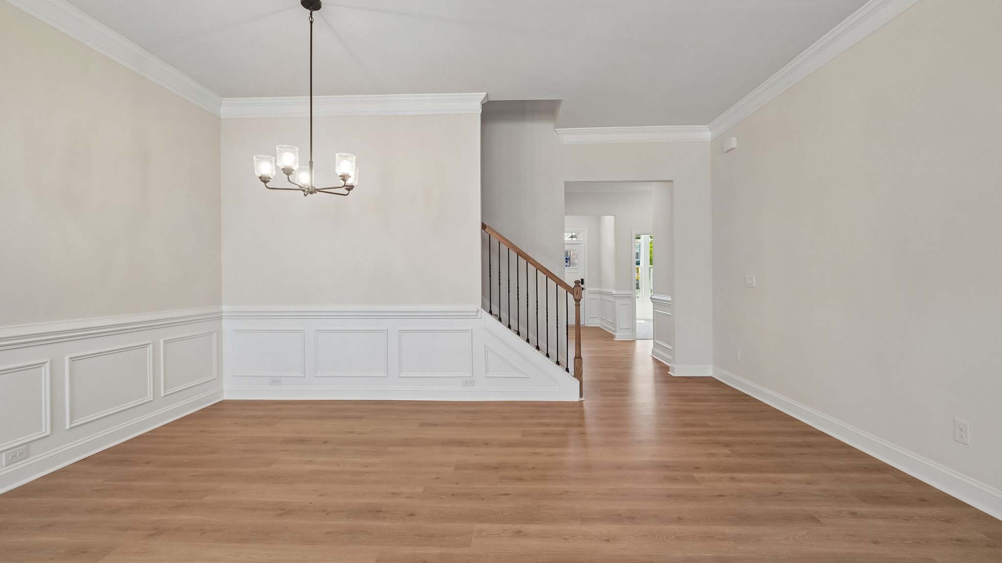 Dining area with wood floors and view of foyer