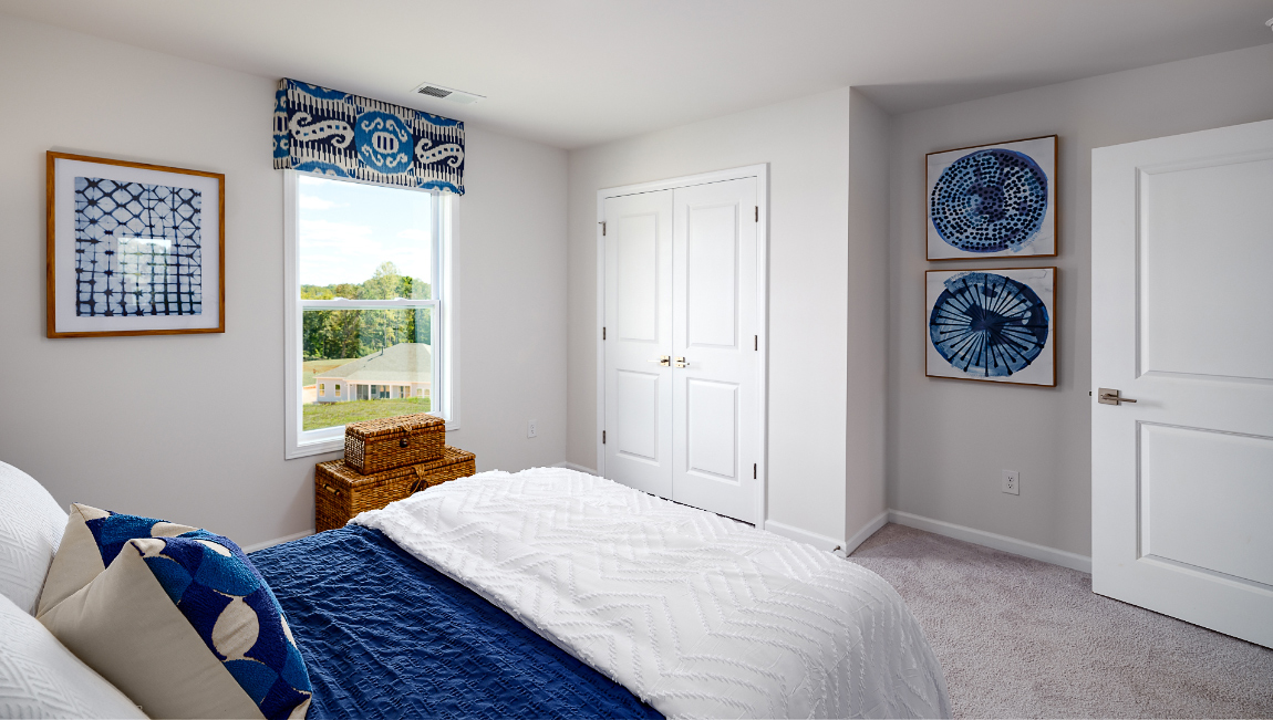 Carpeted bedroom with large window