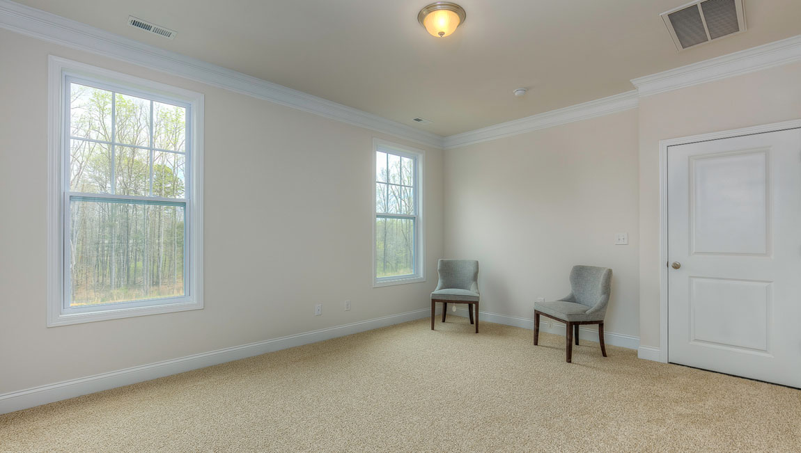 Primary bedroom, carpeted, with three windows