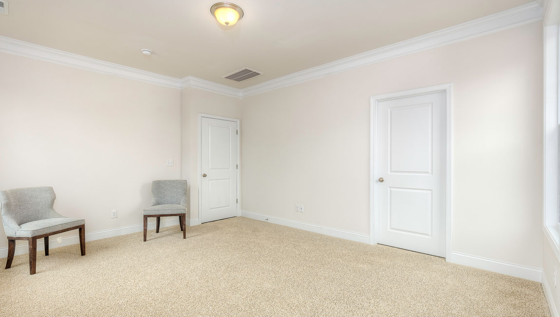 Primary bedroom, carpeted, with three windows