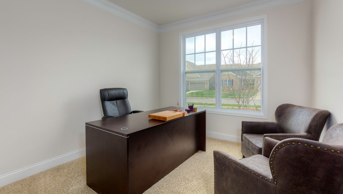 Carpeted bedroom with windows