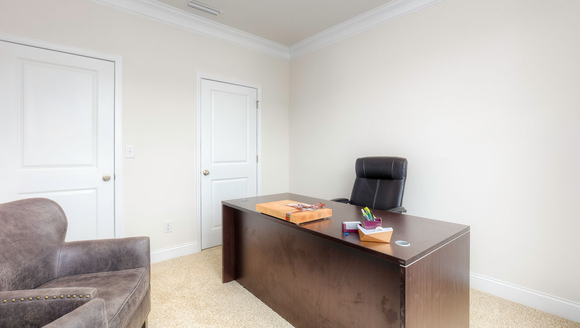 Carpeted bedroom with windows