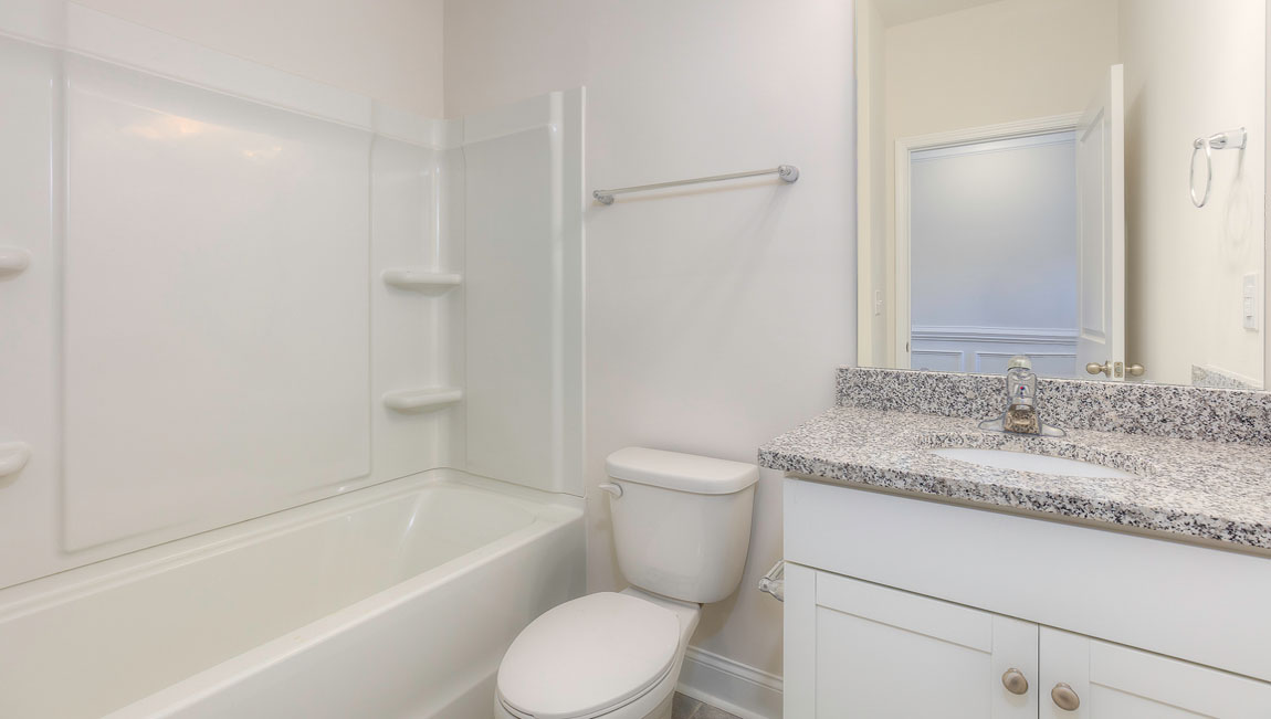 Bathroom with white cabinets and tub shower combination