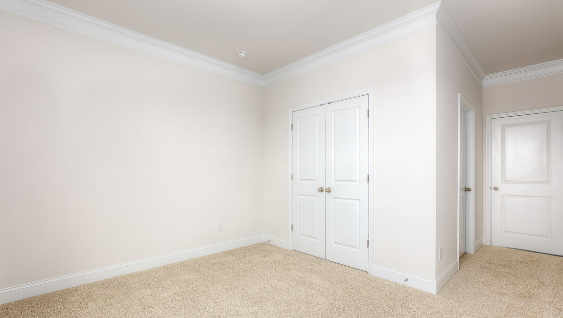 Carpeted bedroom with windows