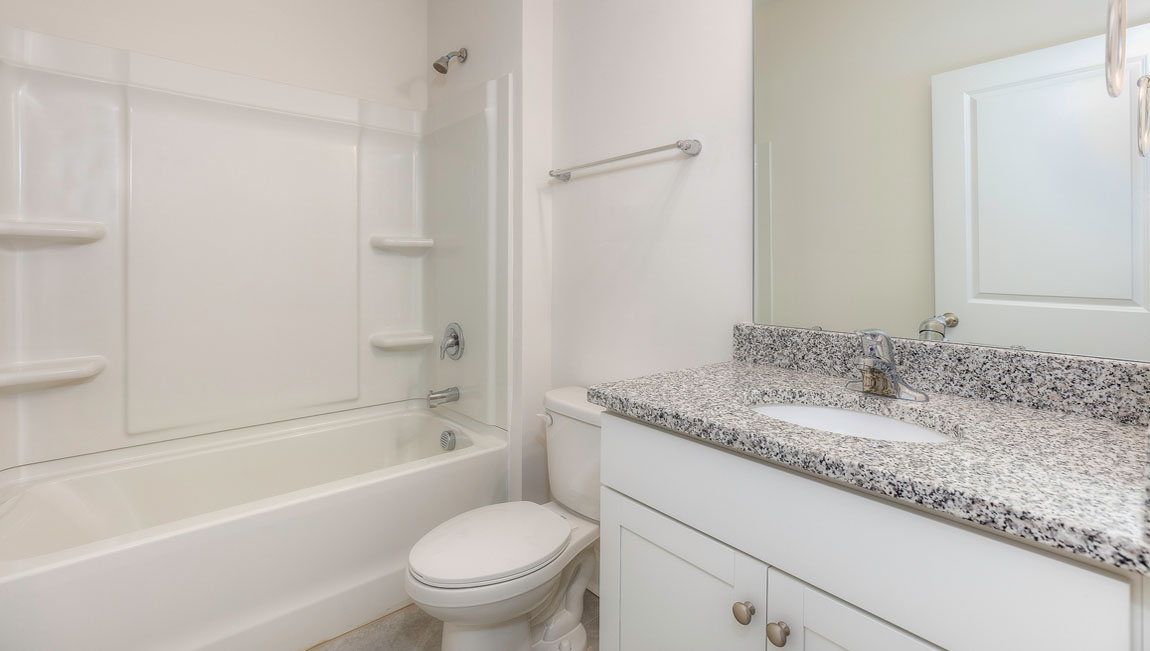 Bathroom with white cabinets and tub shower combination