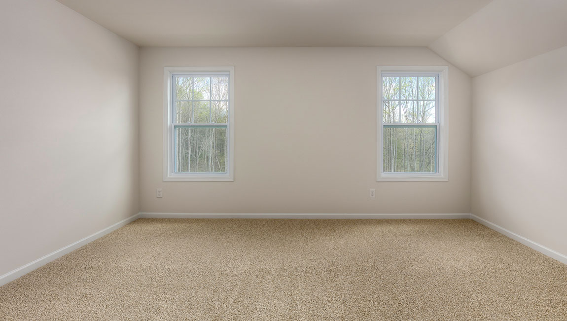 Carpeted bedroom with windows