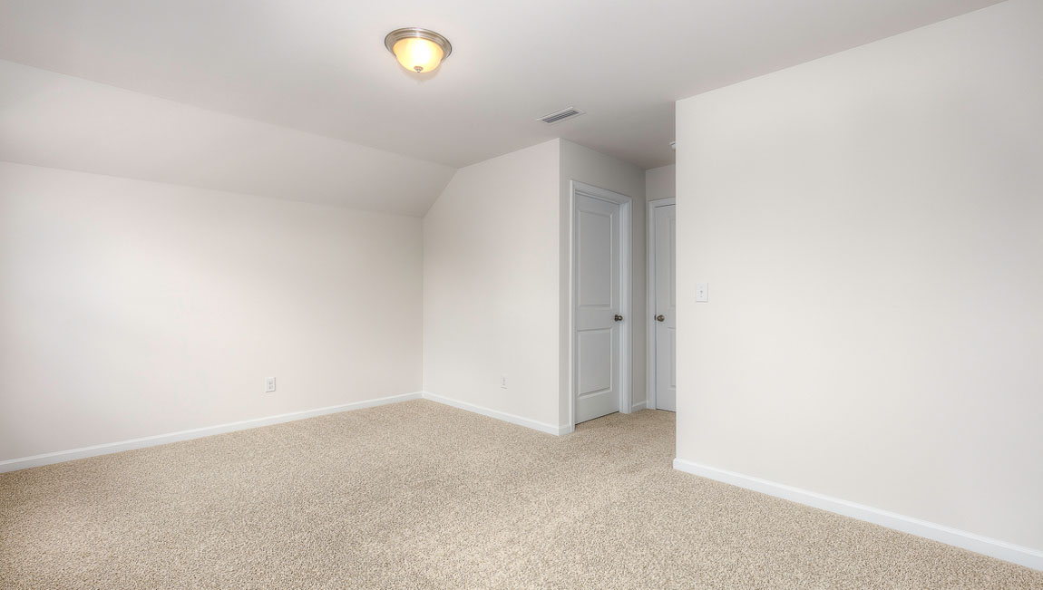 Carpeted bedroom with windows