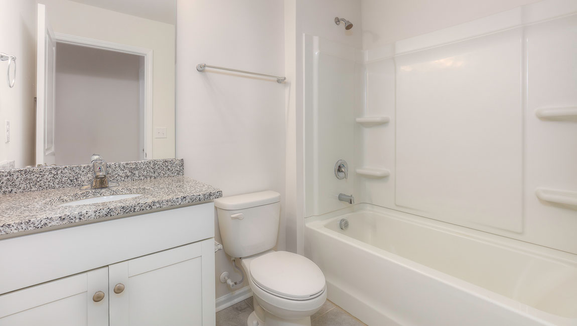 Bathroom with white cabinets and tub shower combination
