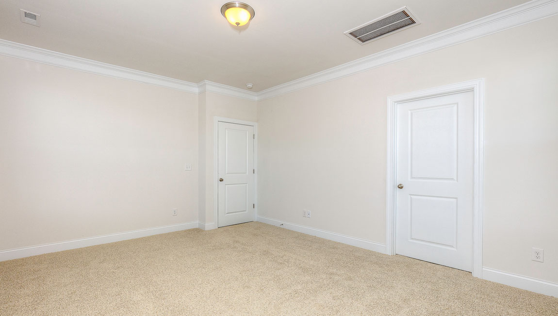 Primary bedroom, carpeted, with three windows
