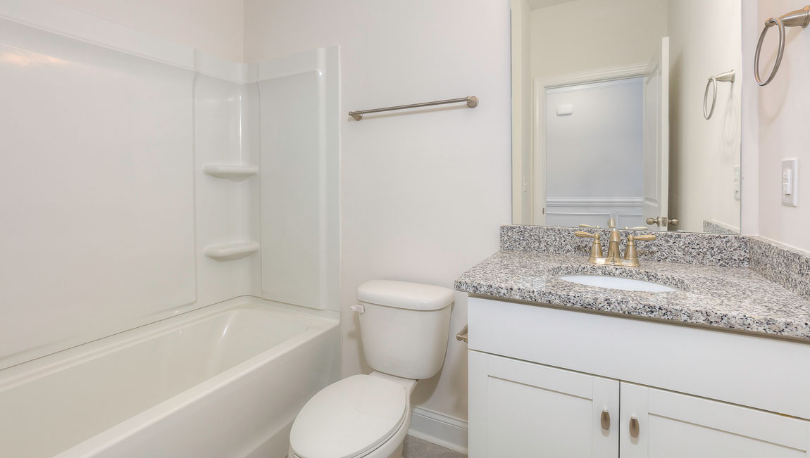 Bathroom with white cabinets and tub shower combination