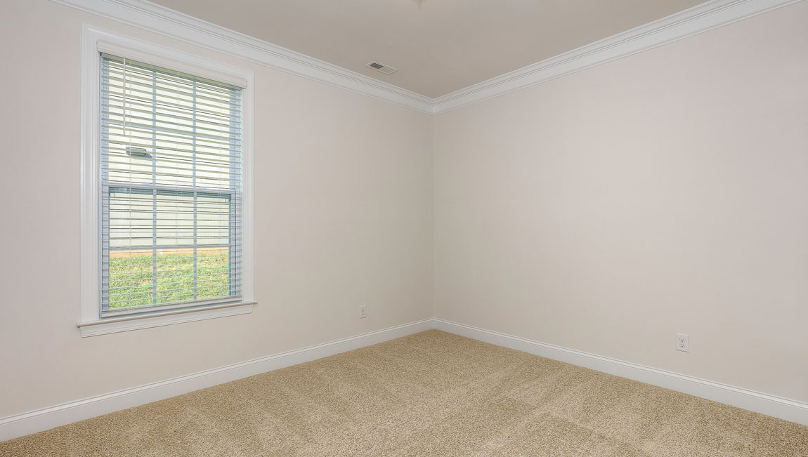 Carpeted bedroom with windows