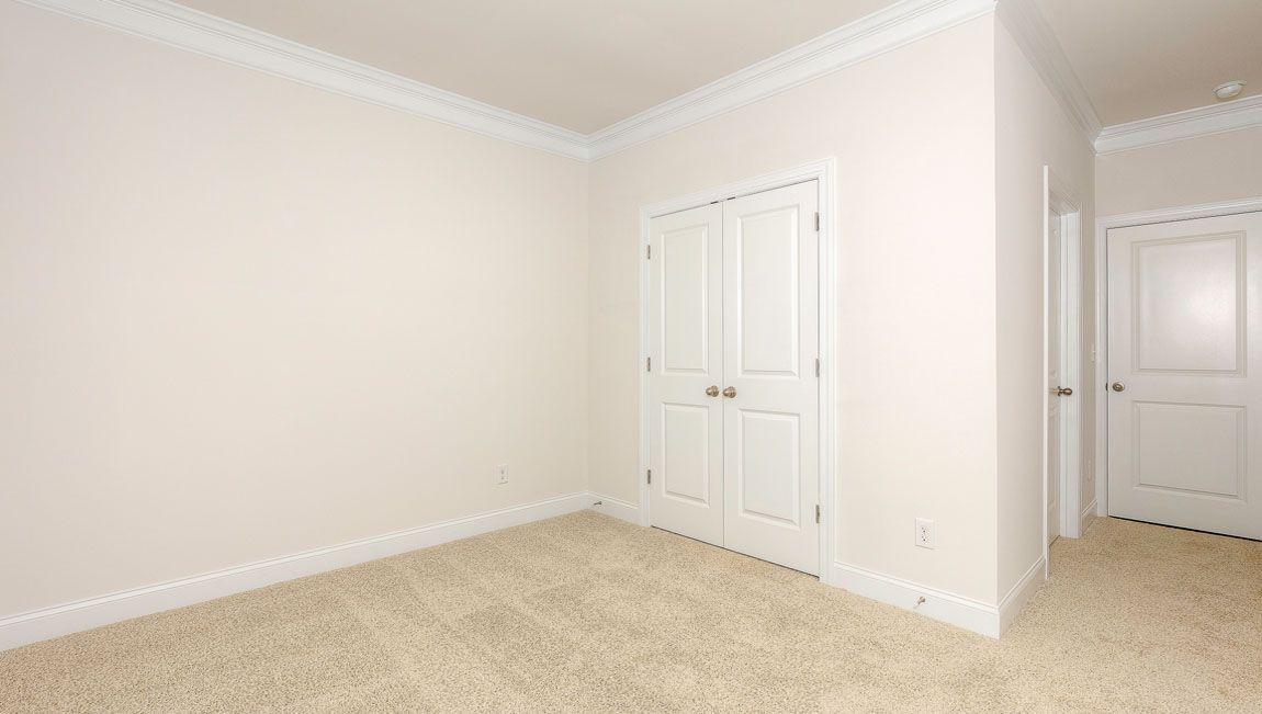 Carpeted bedroom with windows