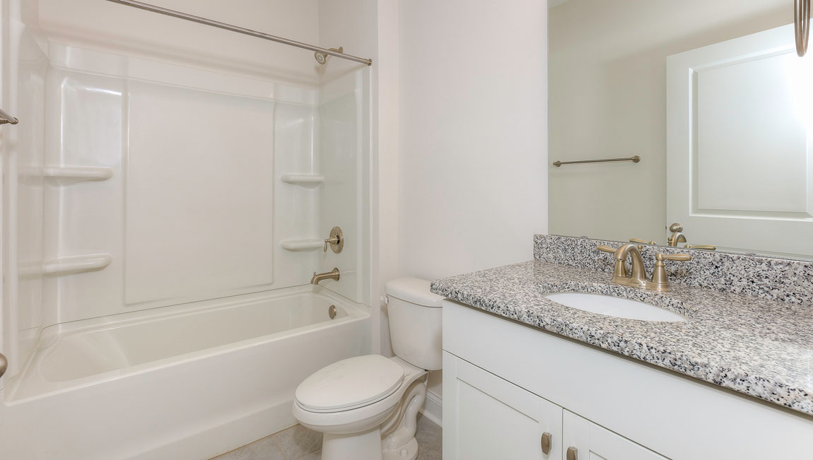 Bathroom with white cabinets and tub shower combination