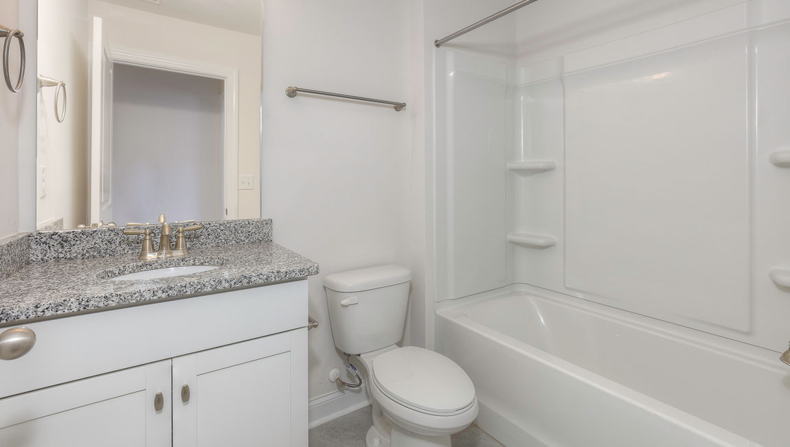 Bathroom with white cabinets and tub shower combination