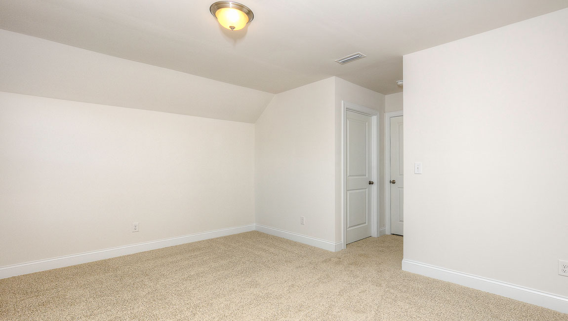 Carpeted bedroom with windows