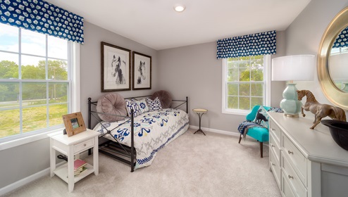 Carpeted bedroom with large windows