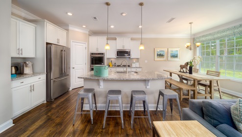 Kitchen and island, wooded floors, and white cabinets