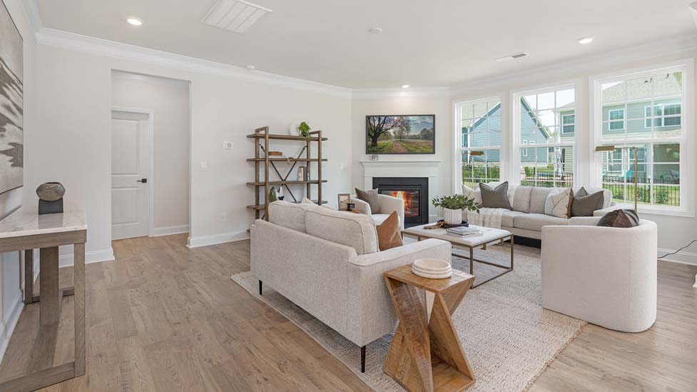 living room beside kitchen with electric fireplace