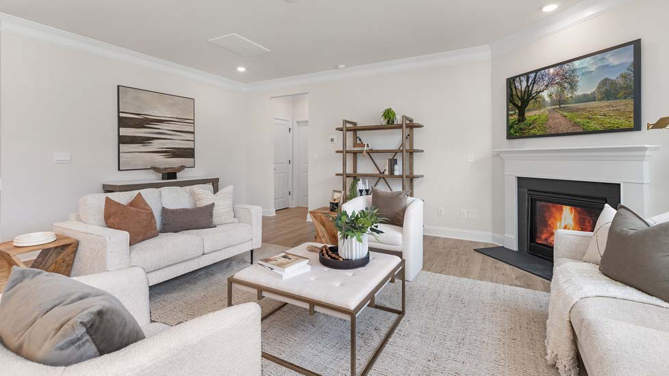 living room beside kitchen with electric fireplace