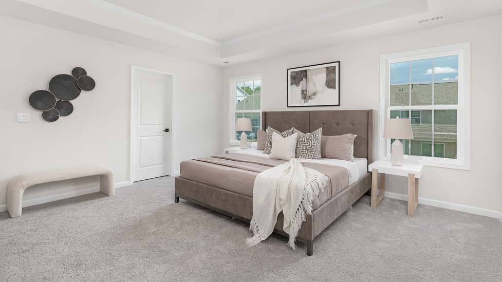carpeted bedroom with large windows