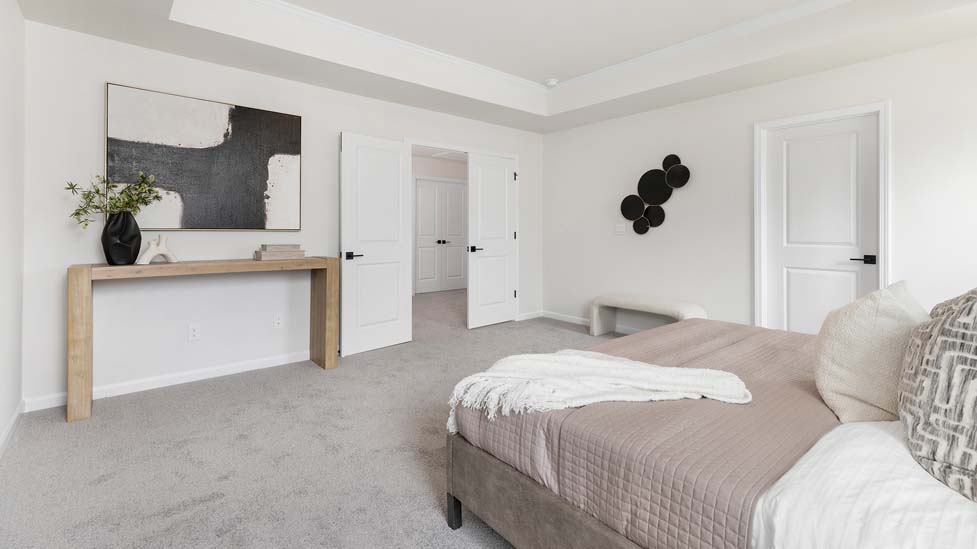 carpeted bedroom with large windows