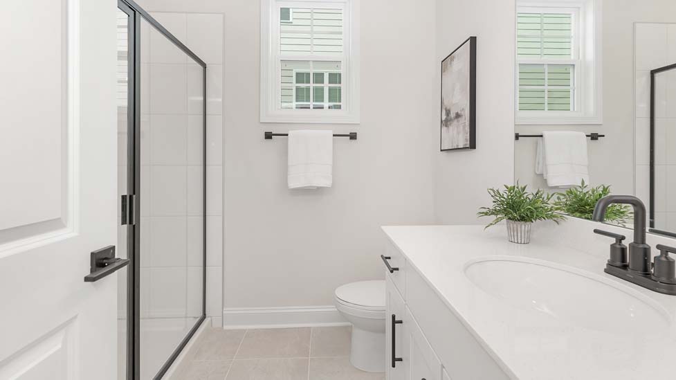 primary bath with walk in shower and double sink vanity
