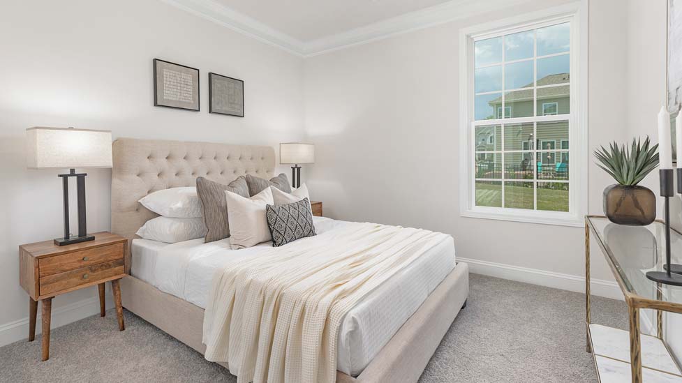 carpeted bedroom with large windows