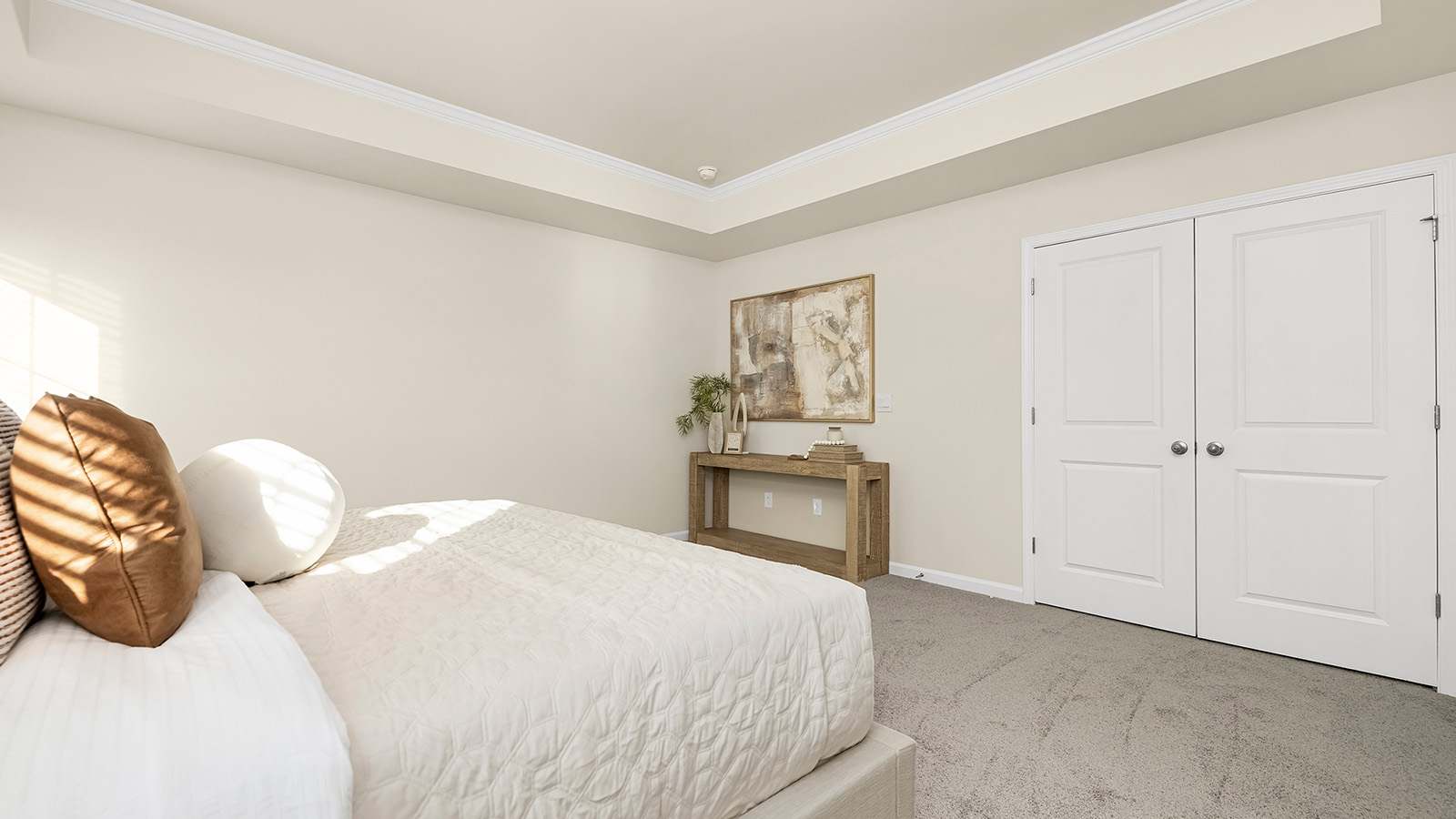 Primary suite carpeted with two windows