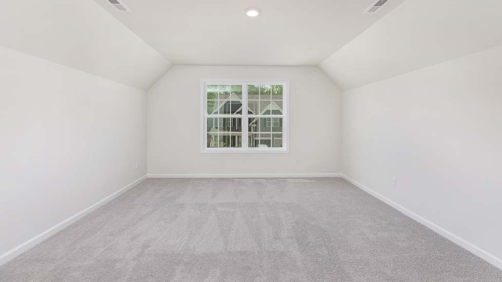 carpeted bedroom with large window