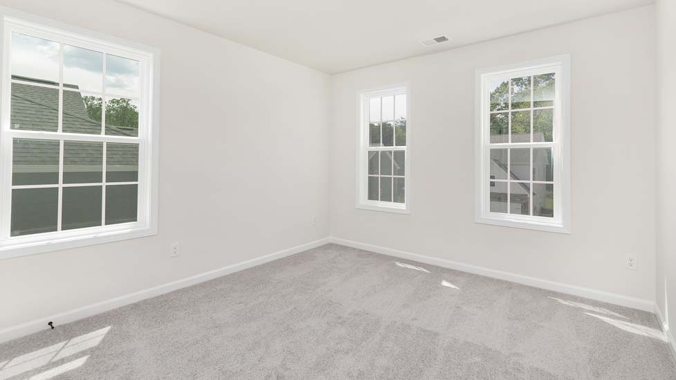 carpeted bedroom with large window