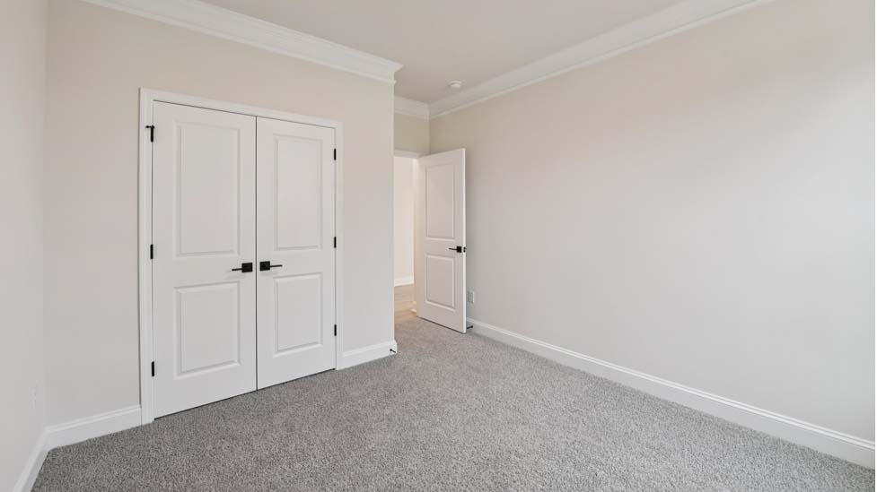Carpeted bedroom with 3 windows