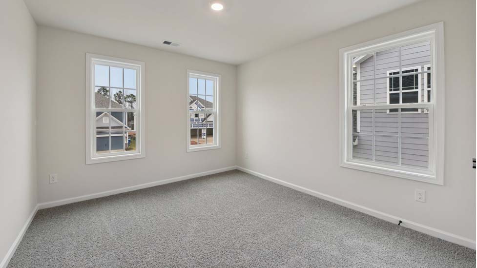 Carpeted bedroom with 3 windows