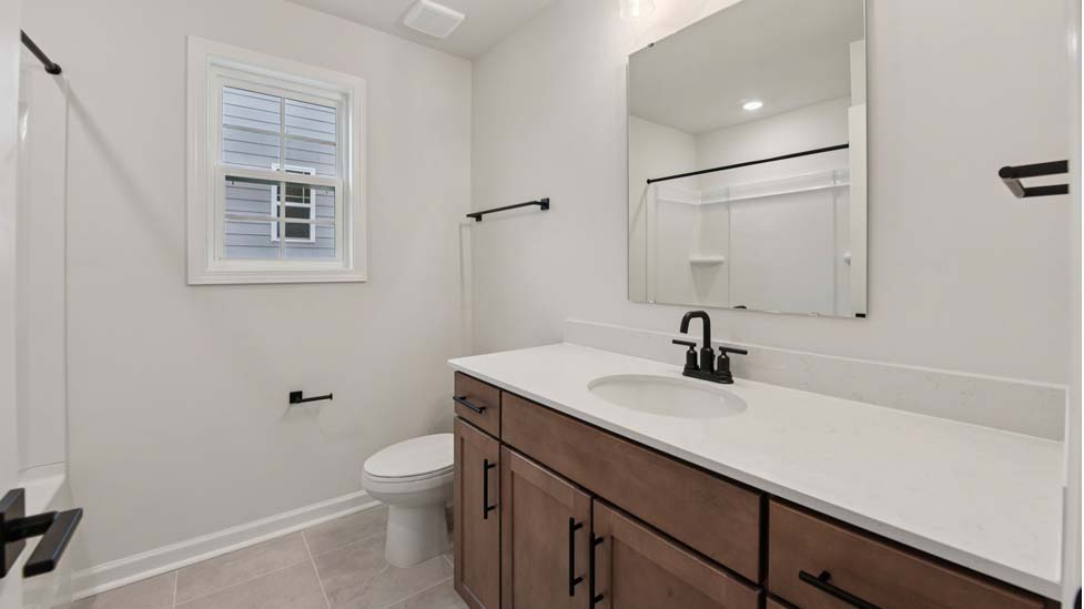 Bathroom with bathtub and white cabinet