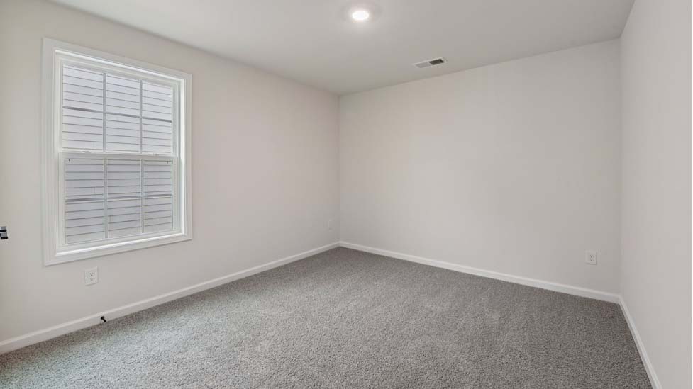 Carpeted bedroom with 3 windows