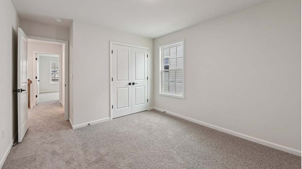 Carpeted bedroom with 3 windows