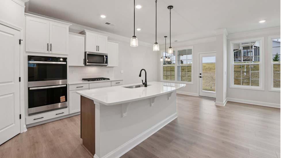 Kitchen and island with white cabinets