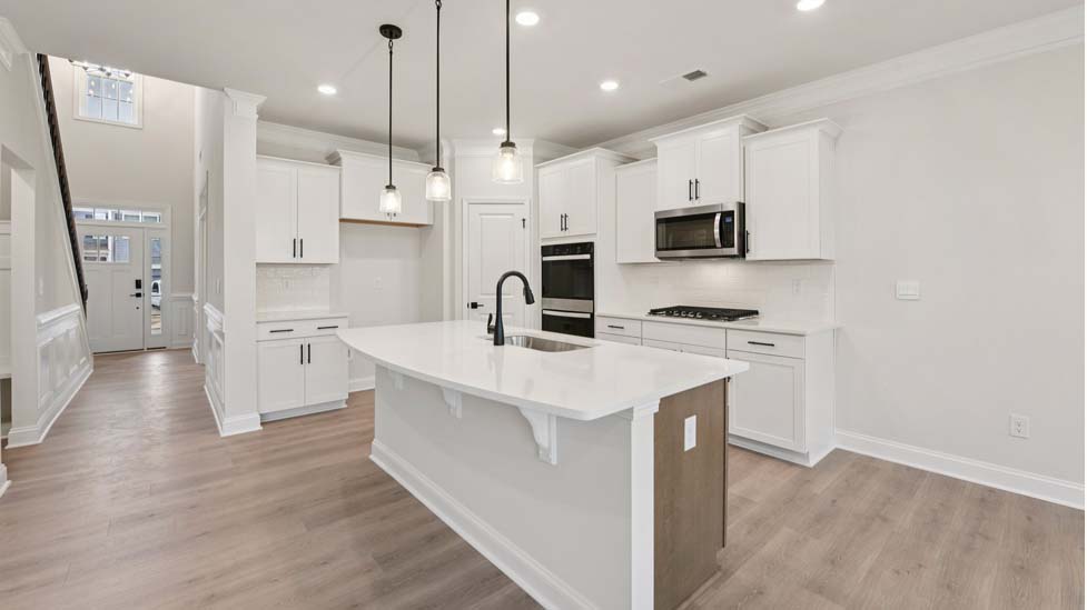 Kitchen and island with white cabinets